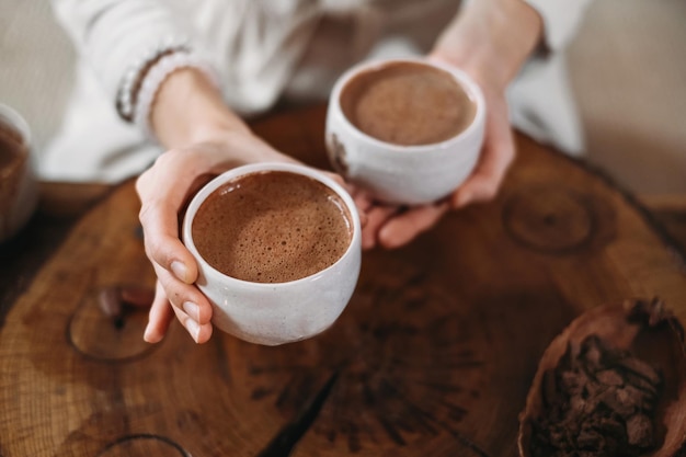 Personne donnant du cacao de cérémonie dans une tasse de boisson au chocolat vue de dessus