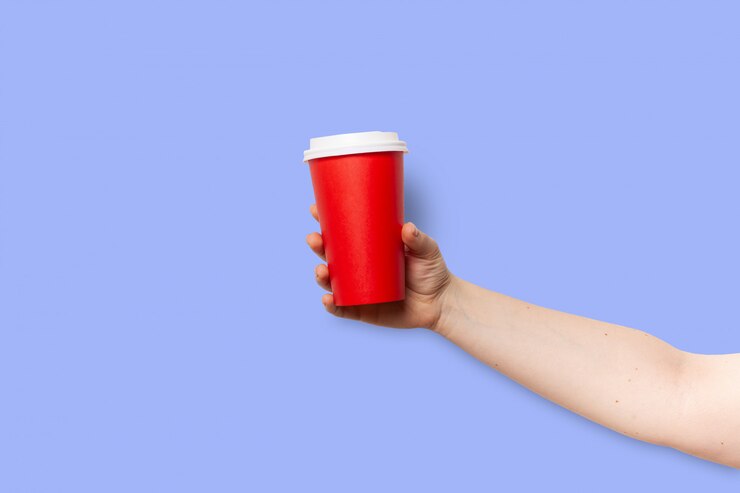 Personne tient une tasse de papier rouge