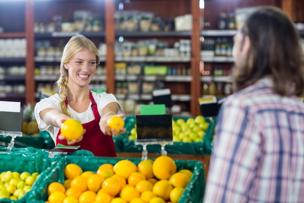 Personnel souriant aidant un homme à faire l'épicerie