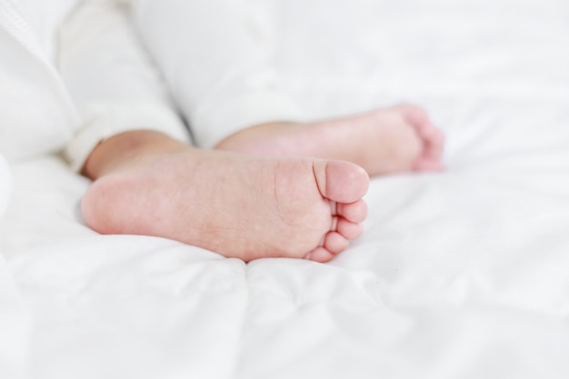 petit bébé pieds sur le lit