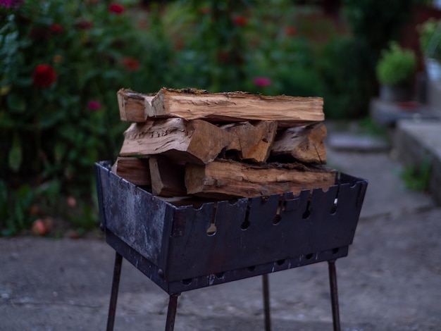 Un petit brasero portable pliant rempli de bois