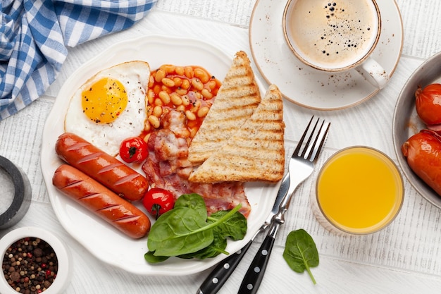 Petit-déjeuner anglais avec des œufs au plat, des haricots, du bacon et des saucisses