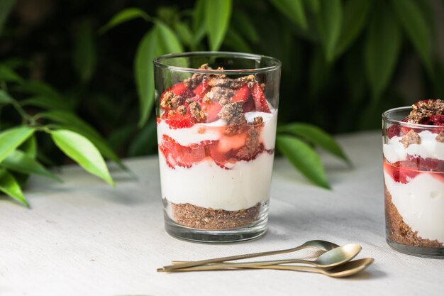 Petit-déjeuner dessert parfait en couches avec biscuit éponge au yaourt et fraise fraîche fond blanc copie espace