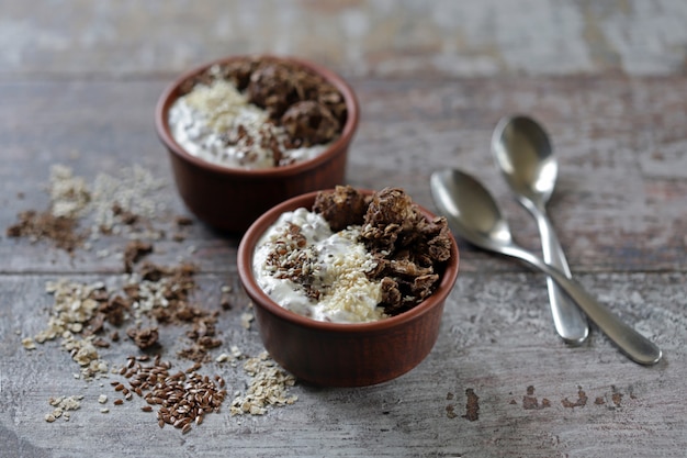 Petit déjeuner ou dessert sain avec du yaourt grec, du granola au chocolat et des graines. Régime céto.