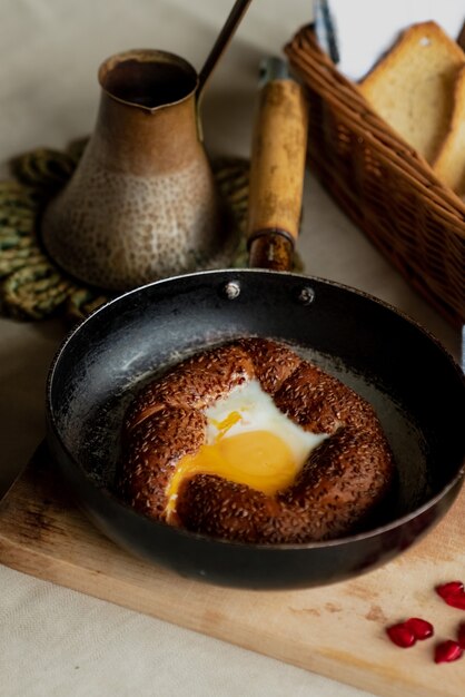 Petit-déjeuner turc, œufs brouillés dans un pain simit dans une poêle, café chez un turc, pain frais