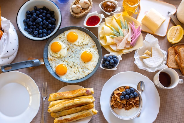 Petit-déjeuner sur la vue de dessus de tableNourriture sur la vue de dessus de tableMuesli aux baies Oeufs fritsJour de repas