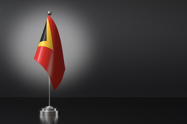 Petit drapeau du Timor oriental devant un fond noir