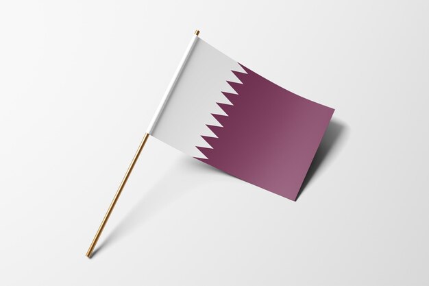 Photo petit drapeau en papier du qatar sur fond blanc