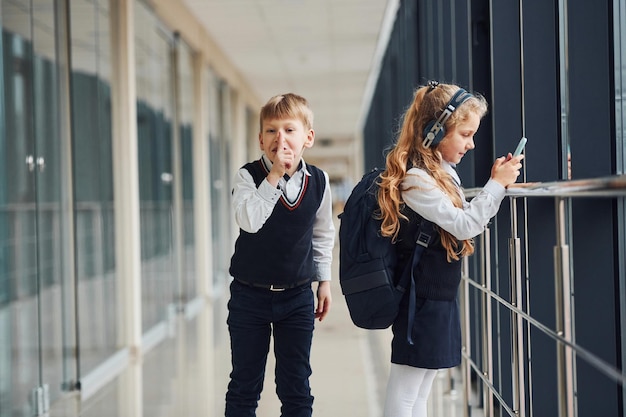 Un petit écolier vole des affaires dans le sac d'une fille alors qu'elle écoute de la musique