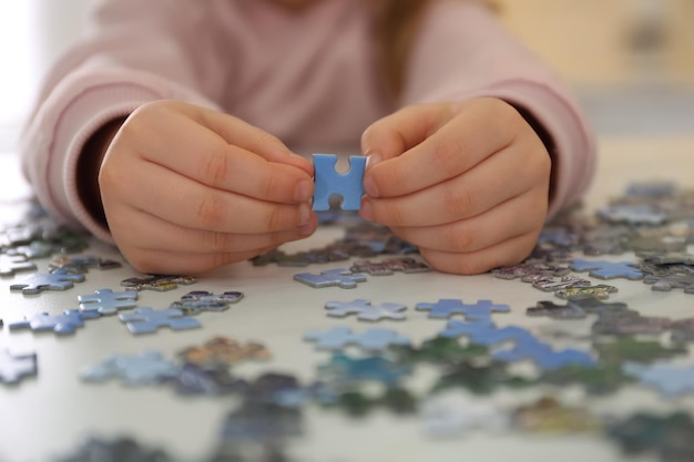 Petit enfant jouant avec des puzzles à table libre