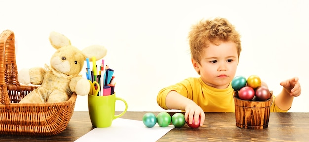 Petit enfant peignant des oeufs de Pâques. Créativité de Pâques pour enfants. Kid garçon décorer l'oeuf de Pâques.