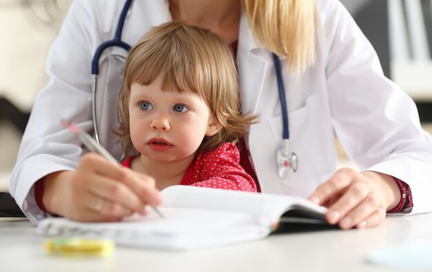 Petit enfant avec sa mère à l'accueil du pédiatre Examen physique portrait de nourrisson mignon aide au bébé mode de vie sain clinique de maladie de l'enfant test de haute qualité et concept de confiance