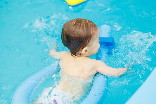 Un petit garçon de 2 ans est dans la piscine Cours de natation pour jeunes enfants