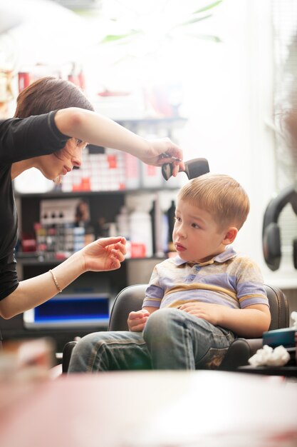 Petit garçon ayant des cheveux coupés au salon