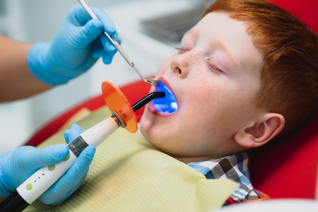 Petit garçon ayant ses dents examinées par un dentiste