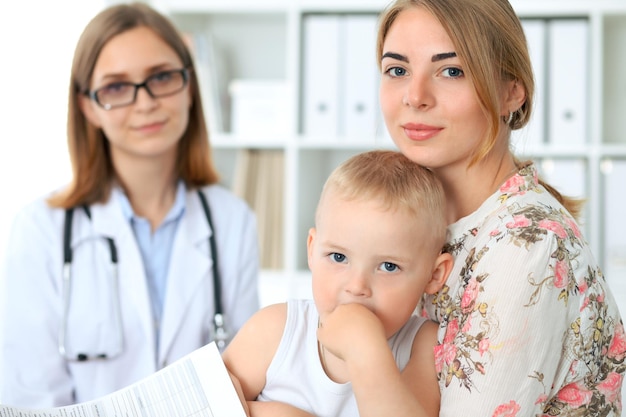 Petit garçon enfant avec sa mère après examen de santé au cabinet du médecin