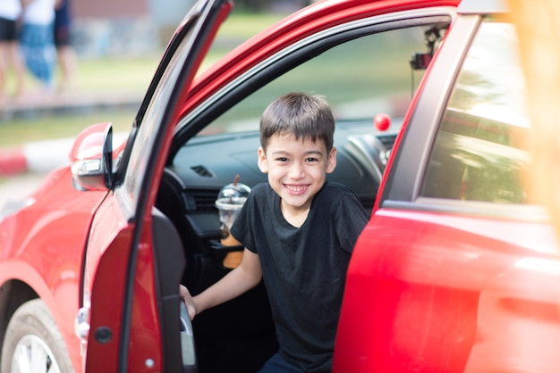 Petit garçon ouvrant la porte de la voiture