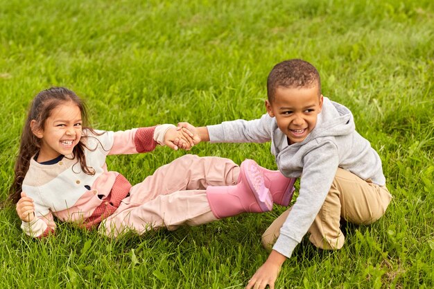 Un petit garçon et une petite fille qui s'amusent dans le parc.