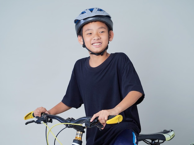 Petit garçon avec vélo sur fond clair