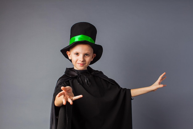 Photo le petit magicien fait des tours le petit garçon porte un costume de magicien et un chapeau magique