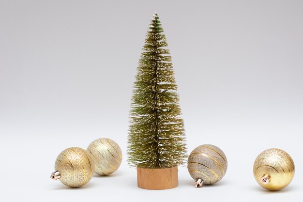 Photo petit sapin de noël et boules de noël dorées