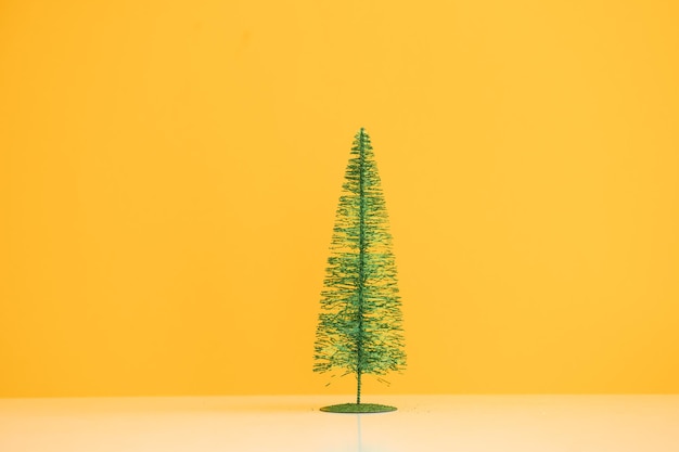 Photo petit sapin de noël sur fond jaune