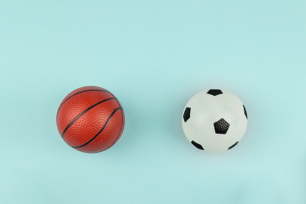 Petite boule orange et blanche pour le sport de basket-ball et de football sur fond bleu.