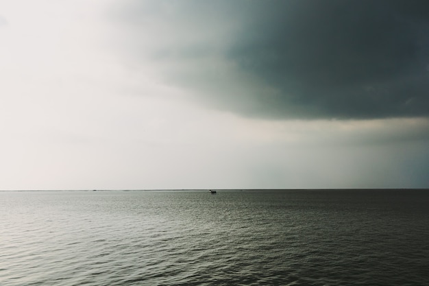 Petite cabane au milieu de la mer sous la tempête à venir