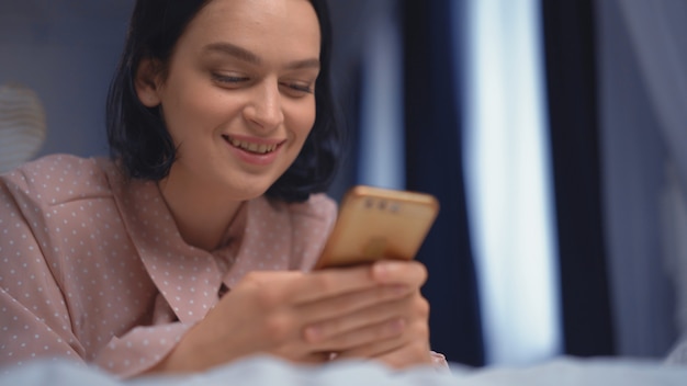 La petite femme à l'aide de son téléphone portable