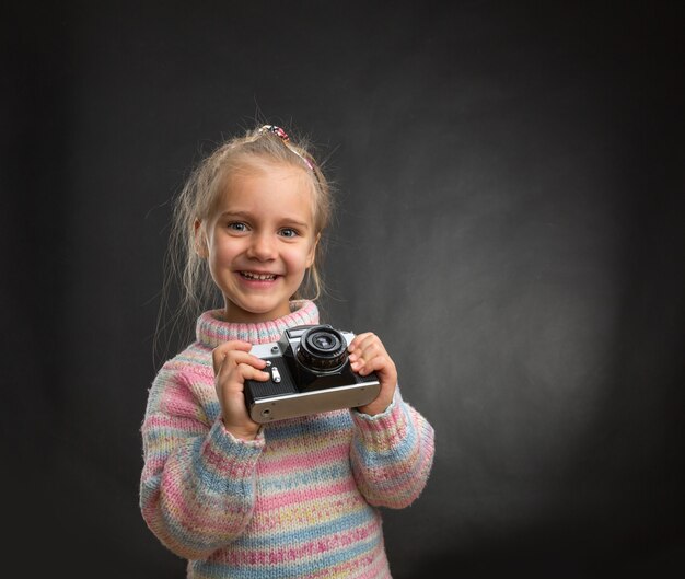 Petite fille avec appareil photo rétro