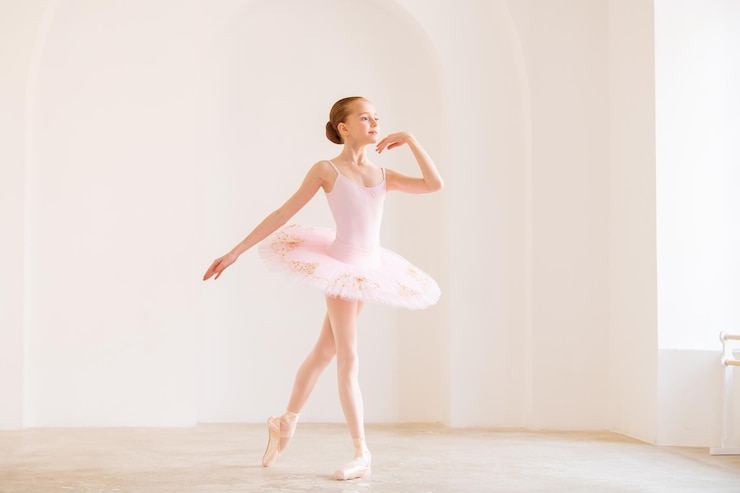 Photo petite fille ballerine danseuse en tutu apprenant la danse classique à l'école de danse