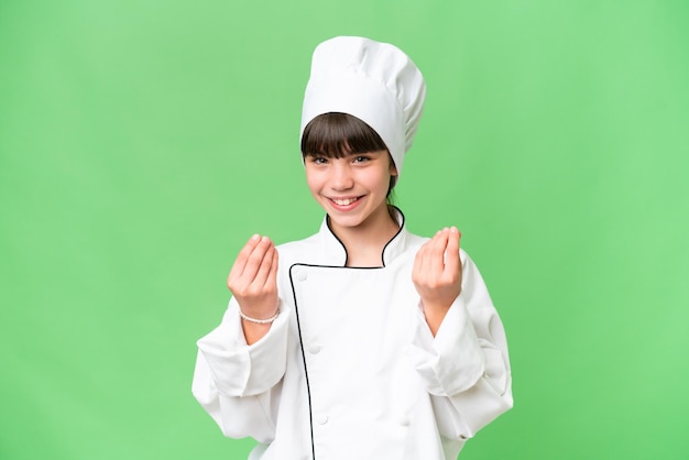 Petite fille de chef caucasien sur fond isolé faisant un geste d'argent