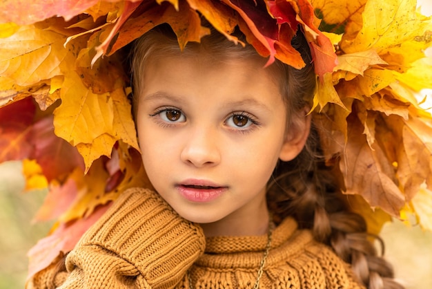 petite fille avec une couronne d'automne de feuilles d'érable.