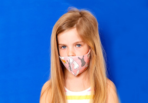 Petite fille dans un masque médical. Prophylaxie au masque pour réduire la propagation des épidémies de coronavirus (covid-19)