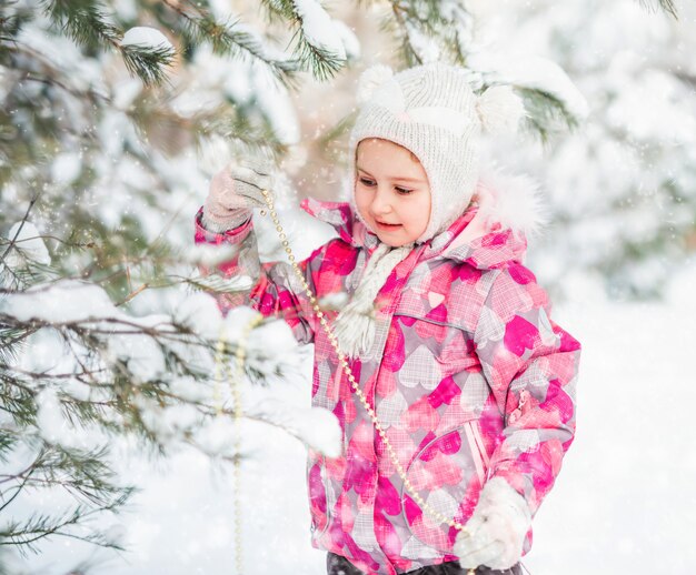 Petite fille, décorer le sapin de Noël