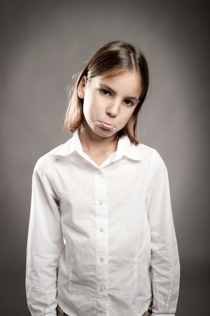 petite fille avec une expression triste sur le visage