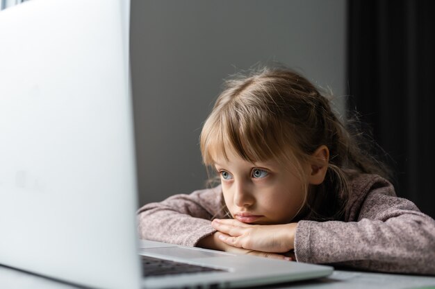 La petite fille fait ses devoirs pour l'école primaire.