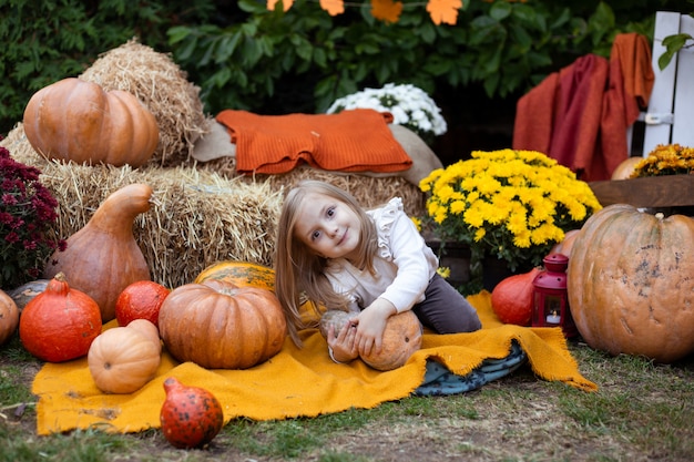 Petite fille jouant avec citrouille à Halloween