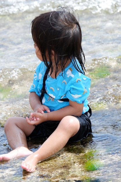 Une petite fille jouant sur la plage