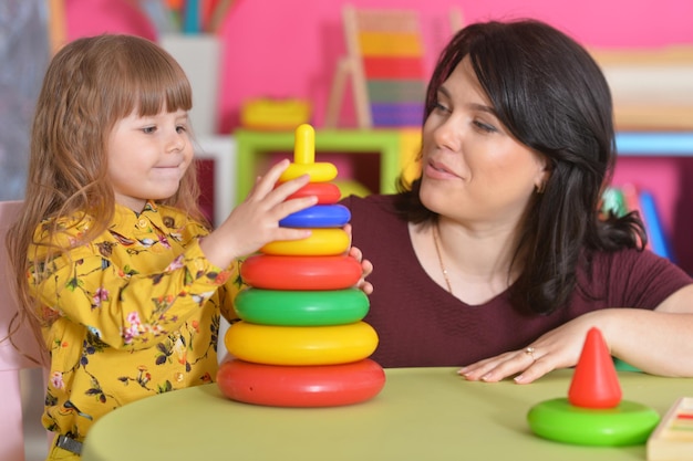 Petite fille jouant avec sa mère à la maison