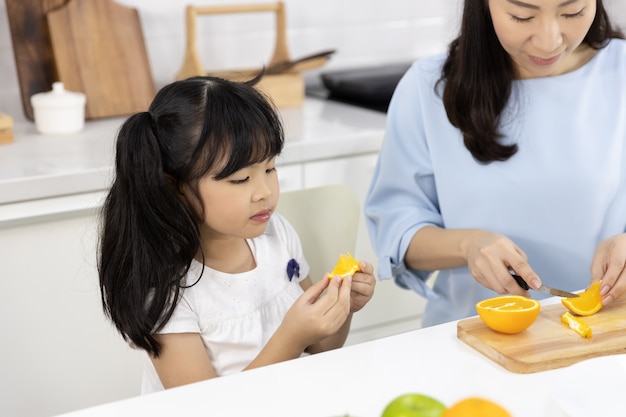 Photo petite fille mangeant des oranges