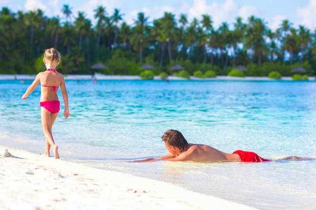 Petite fille et papa pendant des vacances à la plage tropicale