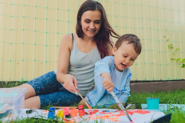 Petite fille peignant avec sa mère dans la cour