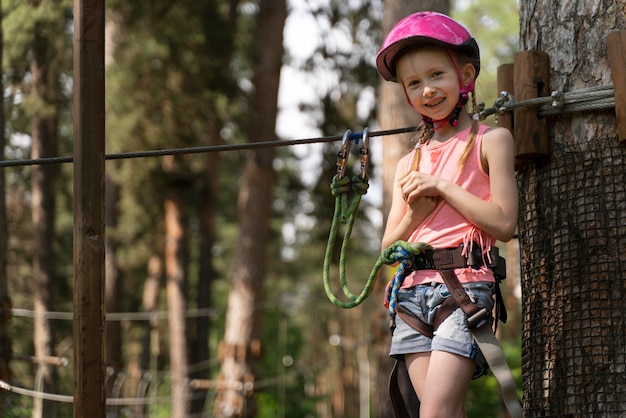 Photo petite fille s'amusant dans un parc d'aventure