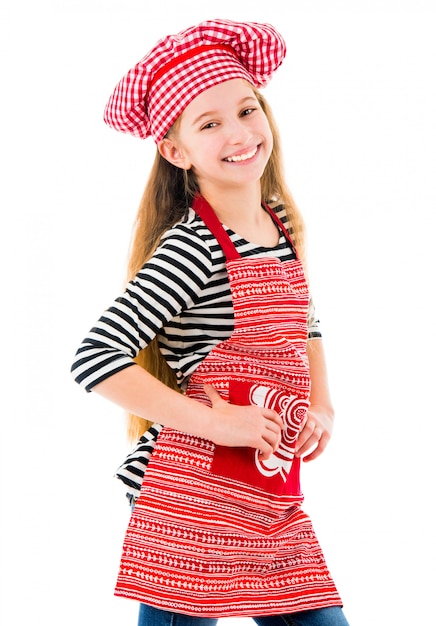 Petite fille en uniforme de chef rouge sourit