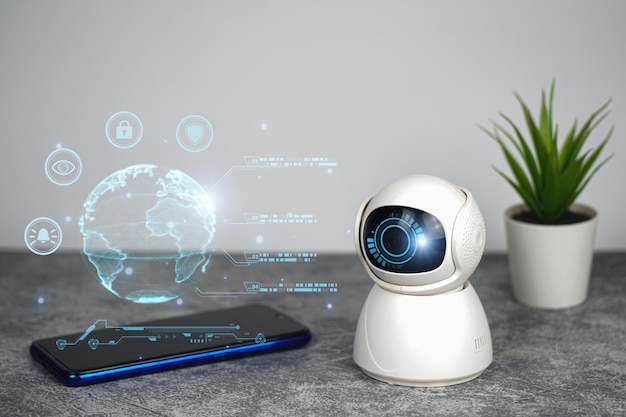 Une petite webcam blanche se trouve à côté d'un ordinateur portable avec un écran qui dit "intelligent" dessus.