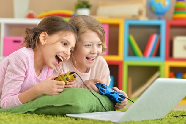 Petites filles jouant à un jeu d'ordinateur