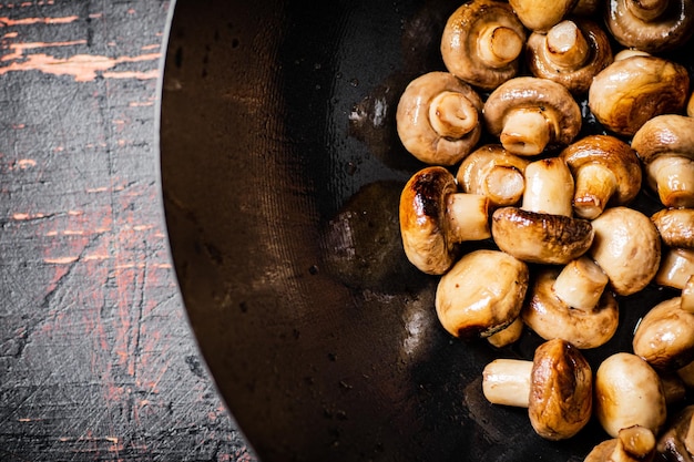 Petits champignons frits dans une poêle à frire