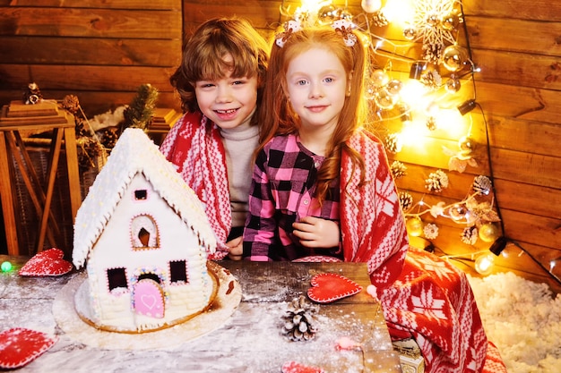 Petits enfants préparant une maison en pain d'épice