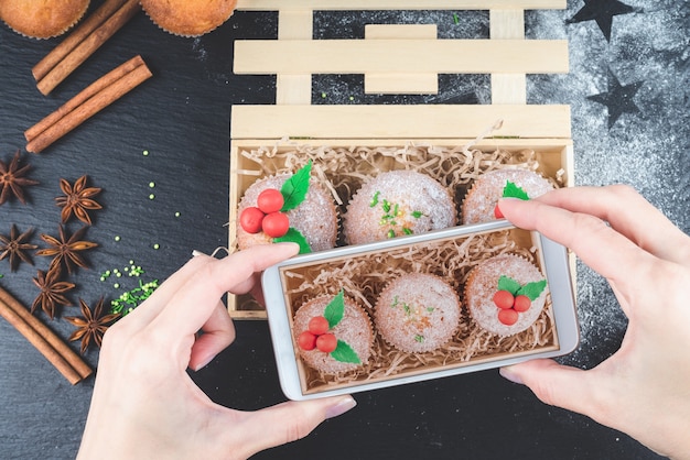 Petits gâteaux de Noël décorés de gui dans une boîte en bois